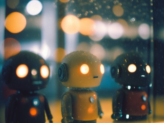 Three toy robots behind glass, bokeh lights.