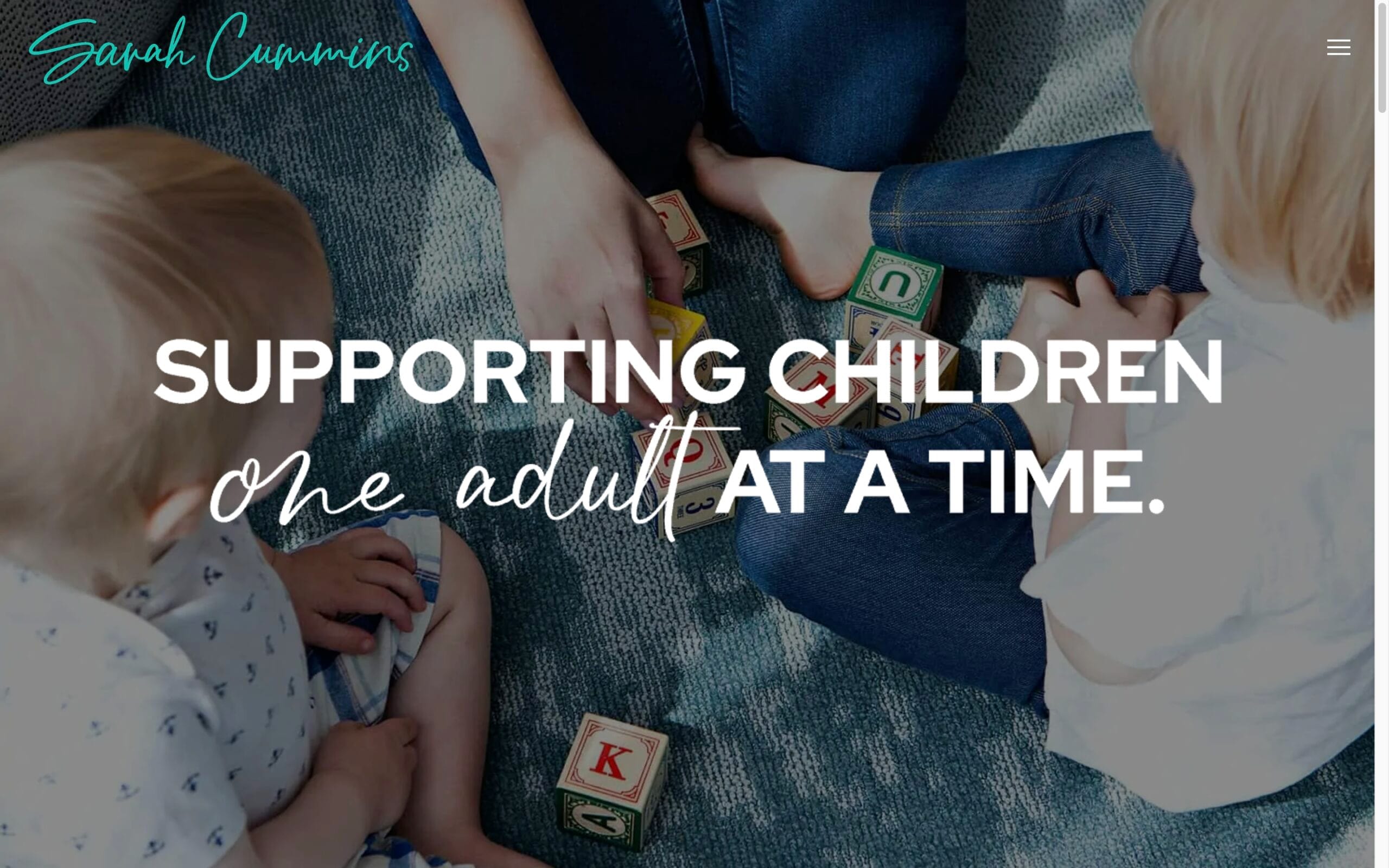 Adults and children playing with alphabet blocks