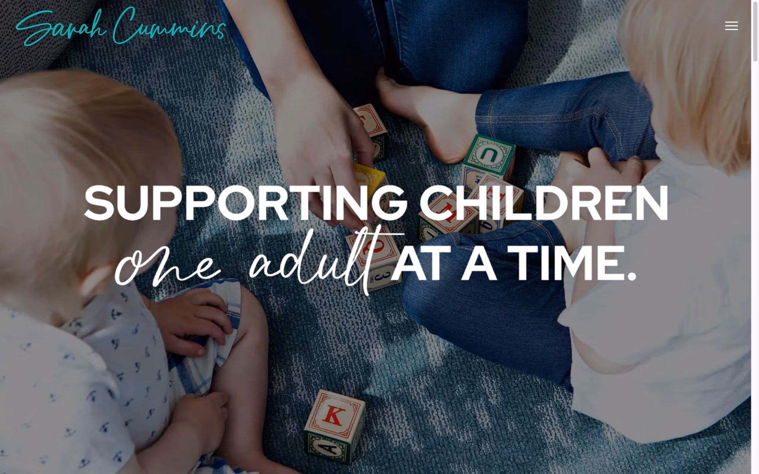 Adults and children playing with alphabet blocks